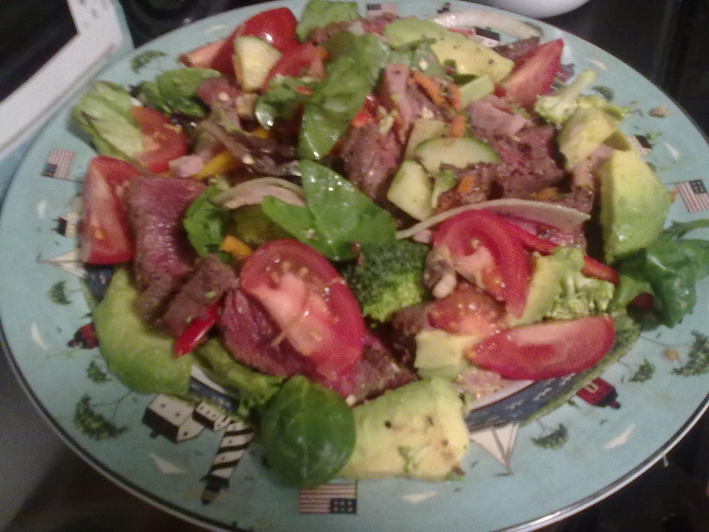Steak salad with diced ham, spinach, broccoli, tomato, avocado, cucumber, red/orange/green peppers, and red onion; dressed with almond slivers, olive oil and balsamic